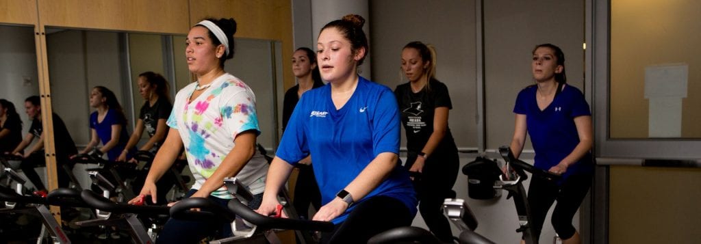 students on bikes at spin class