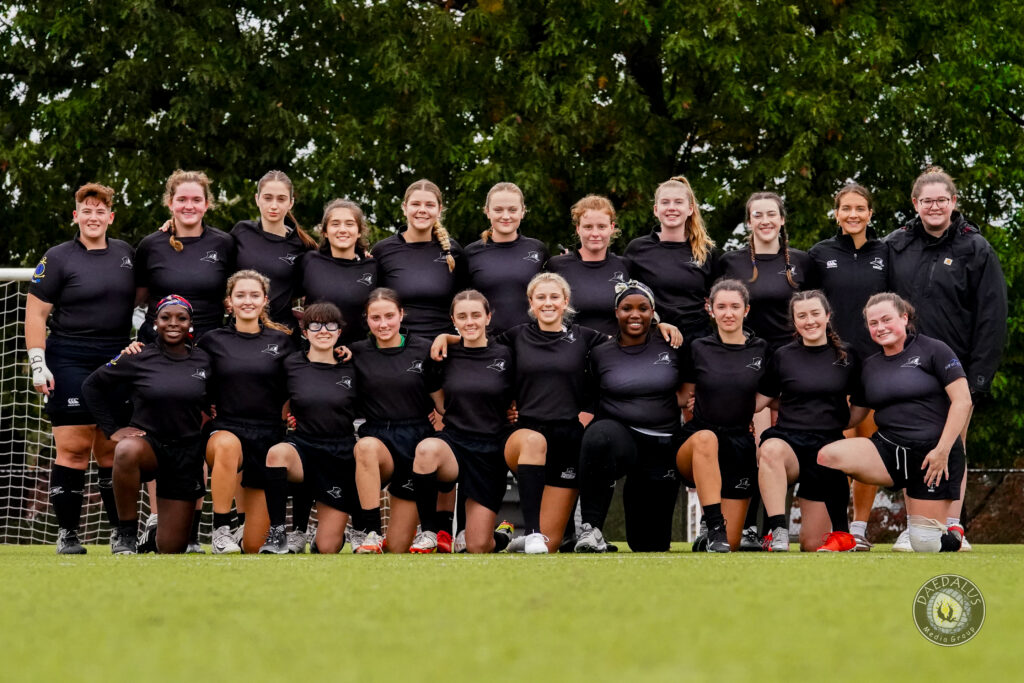 Team photo of rugby team, wearing black uniforms